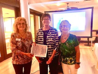 three women holding certificate