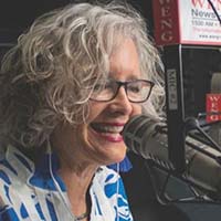 Mary Jones talking into a studio microphone