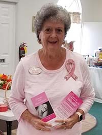 Rita Bertler holding Dollar for Mammograms brochures